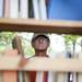 Ann Arbor resident Hugh Gallagher looks at books on a shelf at the Kerrytown BookFest on Sunday. Daniel Brenner I AnnArbor.com